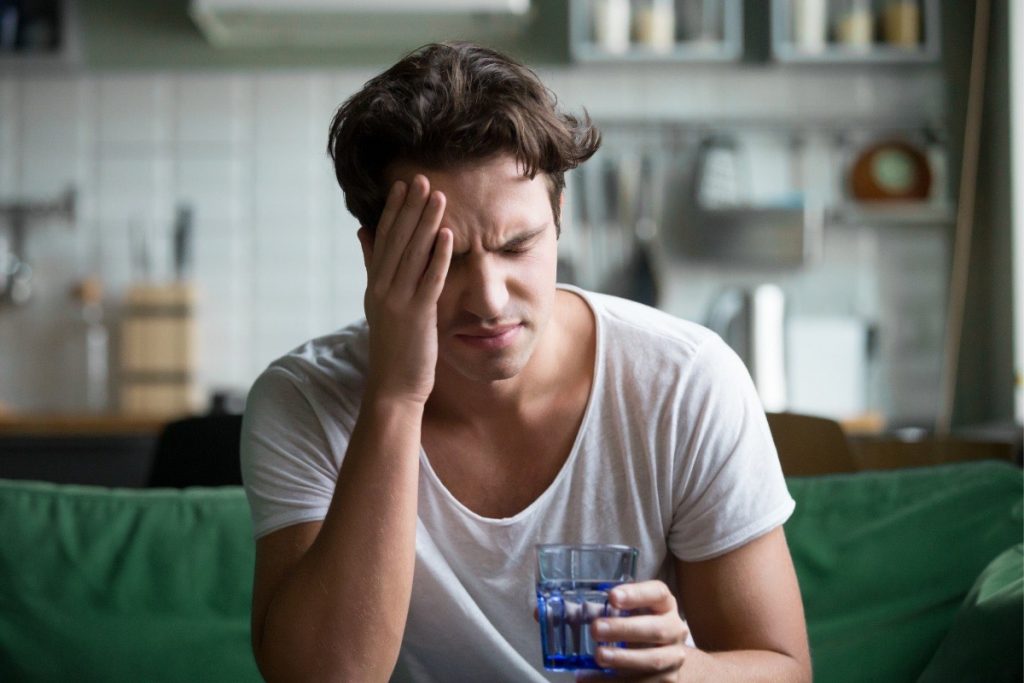 Man rubbing his forehead due to a headache