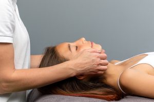 Someone massaging a woman’s face
