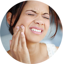 Woman holding her jaw grimacing in pain