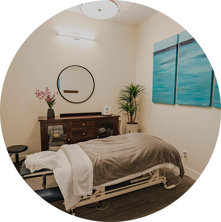 A welcoming treatment room with a painting of a calm ocean on the wall