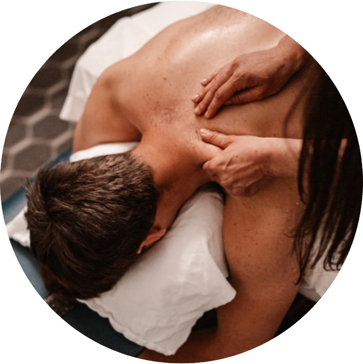 A man lying face down receiving a back massage