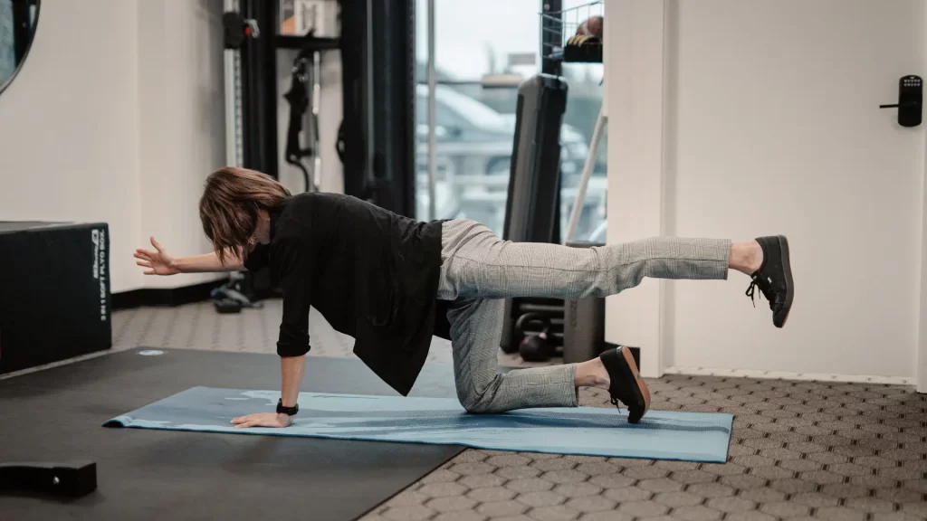 Physiotherapist.demonstrating.straight.leg_.raise