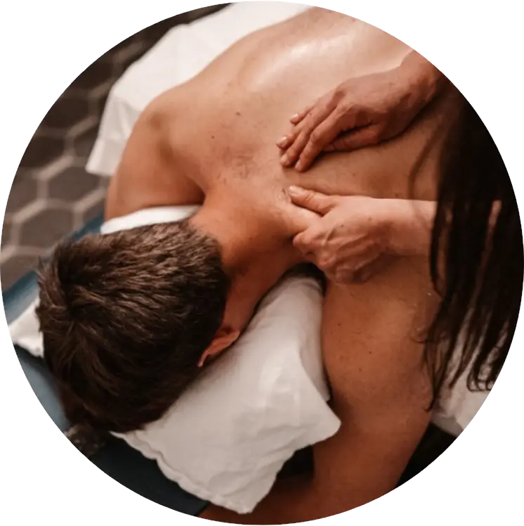 A man lying face down receiving a back massage