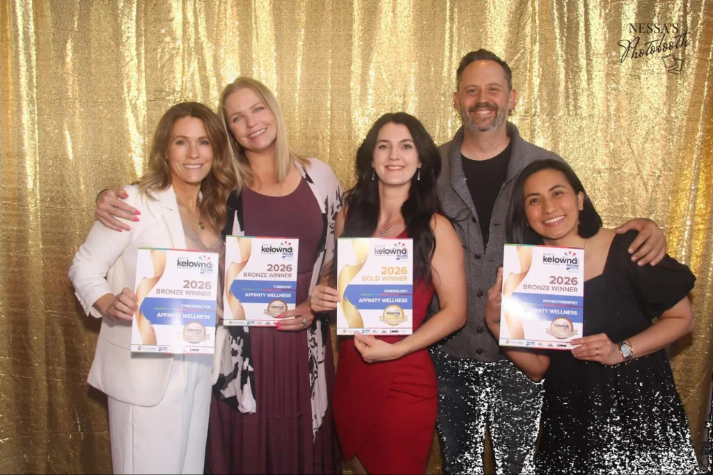 Affinity Family Wellness team at Best of Kelowna 2026 Awards, holding Gold and Bronze winner certificates