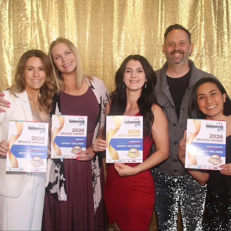 Affinity Family Wellness team at Best of Kelowna 2026 Awards, holding Gold and Bronze winner certificates